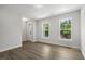 Bright living room featuring wood-look flooring, fresh paint, natural light, and a welcoming entrance at 484 Traditions Grande Blvd # 29, Wake Forest, NC 27587
