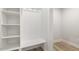 Bright mudroom with white built-in shelving and bench seating and wood-look floors at 484 Traditions Grande Blvd # 29, Wake Forest, NC 27587