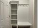 Organized mudroom featuring white built-in shelving, bench, and hooks for storage and convenience at 484 Traditions Grande Blvd # 29, Wake Forest, NC 27587