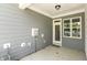 Covered patio with light gray siding, white trim, door, and window at 484 Traditions Grande Blvd # 29, Wake Forest, NC 27587