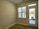 Bright room featuring a large window, door, and wood-look flooring, offering a modern, clean aesthetic at 484 Traditions Grande Blvd # 29, Wake Forest, NC 27587