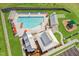 Aerial view of a community pool with seating, a playground, and covered structures at 9237 Kitchin Farms Way # 429, Wake Forest, NC 27587