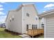 View of the rear exterior of the home featuring a wood deck and modern siding at 9237 Kitchin Farms Way # 429, Wake Forest, NC 27587