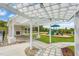 A community area featuring a playground and a fireplace under a pergola at 9237 Kitchin Farms Way # 429, Wake Forest, NC 27587