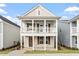 Charming two-story home featuring a welcoming double porch and neutral siding at 9237 Kitchin Farms Way # 429, Wake Forest, NC 27587