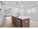 Kitchen featuring an island with seating, stainless steel appliances, and pendant lighting at 9237 Kitchin Farms Way # 429, Wake Forest, NC 27587