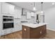 Bright kitchen featuring an island with a white countertop and stainless steel appliances at 9237 Kitchin Farms Way # 429, Wake Forest, NC 27587