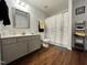 A well-lit bathroom features a gray vanity, modern fixtures, and a shower with a patterned curtain at 129 Sturbridge Dr # 15, Clayton, NC 27520