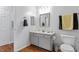 A modern bathroom features a gray vanity, sleek mirror, and a toilet with stylish towel bars at 129 Sturbridge Dr # 15, Clayton, NC 27520