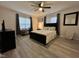 This bedroom features a ceiling fan, a large window, and an accent wall at 129 Sturbridge Dr # 15, Clayton, NC 27520