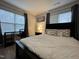 This bedroom features a ceiling fan, a large window, and an accent wall at 129 Sturbridge Dr # 15, Clayton, NC 27520