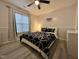 This cozy bedroom has a ceiling fan, neutral walls, and a large window that fills the room with light at 129 Sturbridge Dr # 15, Clayton, NC 27520
