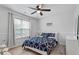 Bright bedroom with a ceiling fan, large window, and stylish blue bedding at 129 Sturbridge Dr # 15, Clayton, NC 27520