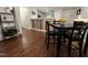A dining room with dark wood floors, a dining table, and a view into the kitchen offers ample space at 129 Sturbridge Dr # 15, Clayton, NC 27520