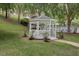 White gazebo near the pool surrounded by green trees and green grass at 129 Sturbridge Dr # 15, Clayton, NC 27520