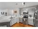 The kitchen has stainless steel appliances, light grey cabinets, and hardwood-style floors at 129 Sturbridge Dr # 15, Clayton, NC 27520