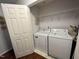 Functional laundry area with washer, dryer, and built-in shelving for storage at 129 Sturbridge Dr # 15, Clayton, NC 27520