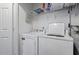 Functional laundry area with washer, dryer, and built-in shelving for storage at 129 Sturbridge Dr # 15, Clayton, NC 27520
