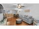 Bright and airy living room with hardwood floors, ceiling fan, and a comfortable gray sofa at 129 Sturbridge Dr # 15, Clayton, NC 27520
