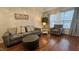 Comfortable living room featuring hardwood floors, a soft gray sofa and natural lighting at 129 Sturbridge Dr # 15, Clayton, NC 27520