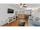 Comfortable living room with wood floors, neutral decor, and a partial view of the adjacent dining and kitchen areas at 129 Sturbridge Dr # 15, Clayton, NC 27520
