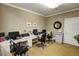 A community office space with computers, desks, and carpeted floors provides residents a place to work at 129 Sturbridge Dr # 15, Clayton, NC 27520