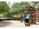 A neighborhood playground with a slide and swings under a canopy of shade trees offers fun for children at 129 Sturbridge Dr # 15, Clayton, NC 27520