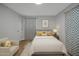 Cozy bedroom with patterned curtains, neutral bedding, and a nightstand with a lamp at 1601 Little Falls Dr, Rocky Mount, NC 27801