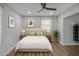 Bright bedroom featuring hardwood floors, neutral colored walls, ceiling fan, and two windows at 1601 Little Falls Dr, Rocky Mount, NC 27801
