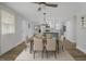 Open-concept dining area with modern chandelier, table set for six, and view into the kitchen at 1601 Little Falls Dr, Rocky Mount, NC 27801