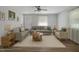 Open living room with hardwood floors, three sofas, a ceiling fan, a window and a decorative front door at 1601 Little Falls Dr, Rocky Mount, NC 27801