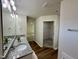 Bathroom featuring wood-look flooring, double vanity, and entrances to bedroom and walk-in closet at 207 Earnest Way # 15, Kenly, NC 27542