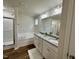 Bathroom featuring a double vanity with a granite countertop, soaking tub, and glass door shower at 207 Earnest Way # 15, Kenly, NC 27542
