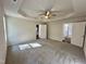 Bright bedroom boasts plush carpet, ceiling fan, and ensuite bathroom and walk-in closet entrances at 207 Earnest Way # 15, Kenly, NC 27542