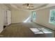 Spacious bedroom features neutral walls, plush carpeting, a ceiling fan, and plenty of natural light at 207 Earnest Way # 15, Kenly, NC 27542