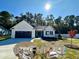 Charming single-story home with white siding, black garage door, and manicured front lawn at 207 Earnest Way # 15, Kenly, NC 27542