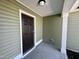 Welcoming covered front porch featuring a dark door and decorative ceiling light fixture at 207 Earnest Way # 15, Kenly, NC 27542
