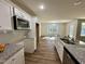 Bright, eat-in kitchen featuring stainless appliances, granite countertops and access to adjacent living space at 207 Earnest Way # 15, Kenly, NC 27542