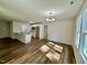 Eat-in kitchen featuring a breakfast bar, stainless appliances, white cabinets, and hardwood floors at 207 Earnest Way # 15, Kenly, NC 27542
