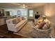 Open living space with hardwood floors, a fireplace, and a comfortable white couch and armchairs at 207 Earnest Way # 15, Kenly, NC 27542