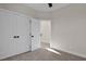 Bedroom featuring carpeted floors and white closet doors with black hardware at 2401 E Main St, Durham, NC 27703