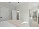 Bright bedroom with a ceiling fan, and access to the ensuite bathroom at 2401 E Main St, Durham, NC 27703