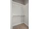 A well-organized closet with double rods for maximum storage capacity and carpeted floor at 2401 E Main St, Durham, NC 27703