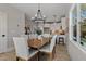 Elegant dining room with modern chandelier and wood table open to the modern kitchen at 2401 E Main St, Durham, NC 27703