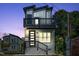 Modern two-story home boasts a balcony, clean lines, and a stylish gray brick facade at 2401 E Main St, Durham, NC 27703