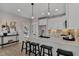 Bright kitchen with white cabinets, quartz countertops, stainless steel appliances, and island with seating at 2401 E Main St, Durham, NC 27703