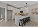 Modern kitchen features white cabinetry, stainless steel appliances, and island with bar stool seating at 2401 E Main St, Durham, NC 27703