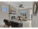 Stylish living room with fireplace, modern ceiling fan, and bright windows at 2401 E Main St, Durham, NC 27703