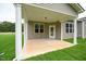 Covered back porch with white pillars and an exterior door surrounded by green grass at 138 Abingdon Farms Dr, Selma, NC 27576