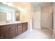 Bathroom featuring double vanity with dark wood cabinets and large mirror at 138 Abingdon Farms Dr, Selma, NC 27576